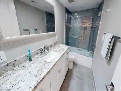 Just Steps to the Sandy Beach from this Two Bedroom Condo